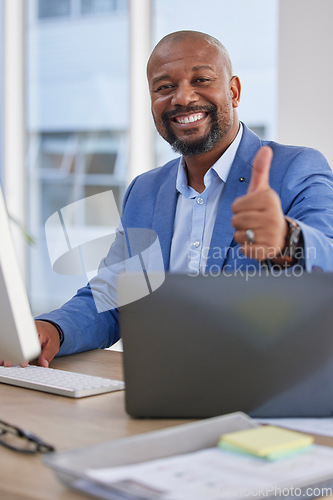 Image of Happy black man, laptop and thumbs up for winning, good job or success in marketing at the office desk. Portrait of African American male showing thumb emoji, yes sign or like in thanks by computer