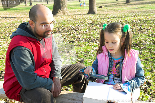 Image of child and father reading the book