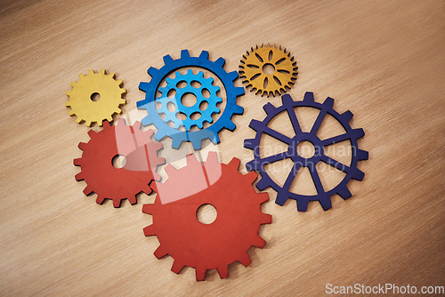 Image of Mechanism, brainstorming and connection with cog gear on table for teamwork, solidarity and development. Collaboration, strategy and solution with machine parts for structure, cooperation or progress