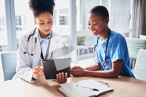 Image of Tablet, black woman or doctors with medical research reading news or tests results in hospital together. Teamwork, digital tech or African nurses planning or speaking of healthcare report on website