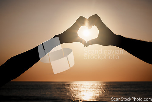 Image of Beach sunset silhouette, couple and heart hand sign for travel freedom, outdoor peace or nature beauty. Wellness, sky flare and emoji gesture for ocean love, sun light or sea water on summer holiday