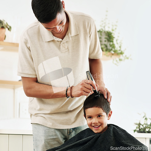 Image of Family, children and haircut with a father shaving the hair of his son together in the home for grooming. Kids, barber and hairstyle with a man cutting the head of his son as a hairdresser in a house