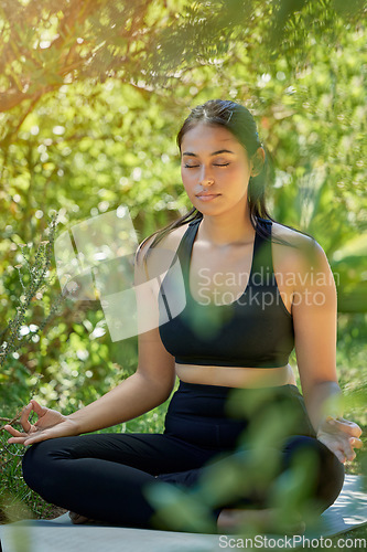 Image of Lotus pose, yoga and woman in nature for wellness, peace or exercise on forest floor. Zen, meditation and girl relax in mental health, zen or training, chakra or balance cardio workout in countryside