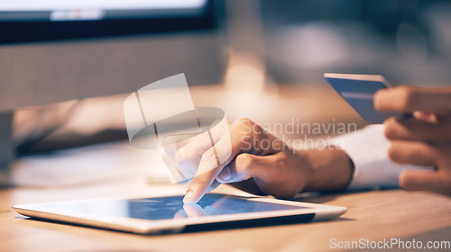 Image of Hands, tablet and credit card for ecommerce, online shopping or banking at night on office desk. Hand of employee shopper typing on touchscreen for internet purchase, bank app or transaction on table