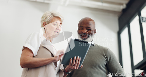 Image of Business team, tablet and talking while planning strategy together in a office while online for marketing, inspiration and idea for project. Woman and black man with technology for collaboration