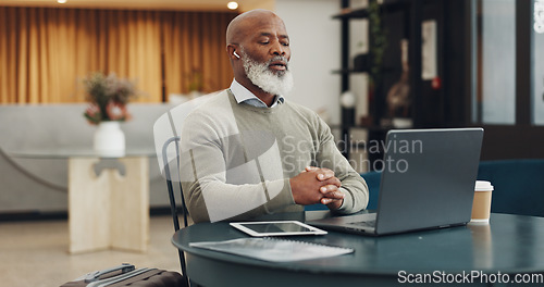 Image of Earphones, laptop and black man on video call in office, online meeting or video conference. Webinar, mature and.businessman talking on computer in virtual meeting, workshop or interview video