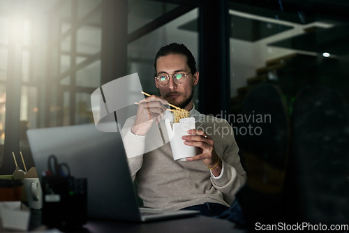 Image of Laptop, noodles and business man eating in office at night while finishing project. Ramen break, chinese food and male employee eat takeaway dinner while reading email on computer in dark workplace.