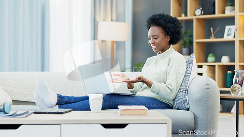 Image of Happy black woman waving while using a laptop to make a video call in the living room. Young african american female excited to have a casual chat with friends or family at home during lockdown