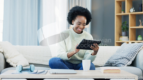 Image of Woman using a digital tablet at home. Beautiful and happy young female student smiling and laughing while browsing apps, scrolling social media and streaming series online to enjoy over the weekend