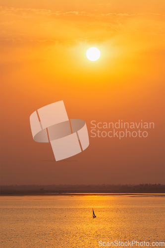 Image of Yacht boats in lake on sunset