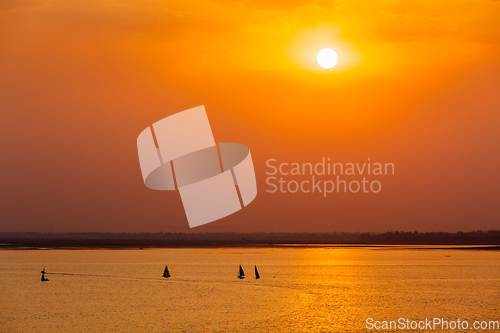 Image of Yacht boats in lake on sunset