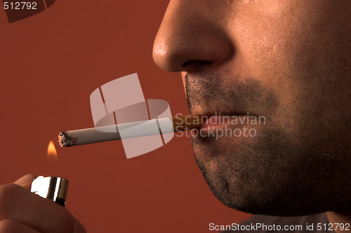 Image of man lighting a cigarette