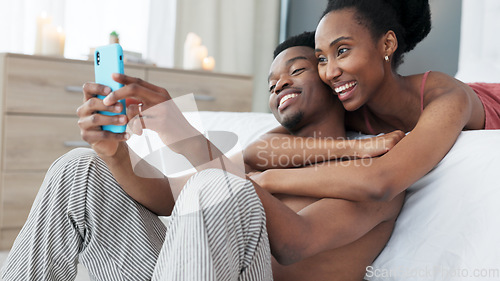 Image of Portrait, phone and couple take a selfie in bedroom together and sharing it on social network app online in the morning. Social media, smile and black woman loves taking pictures with African partner