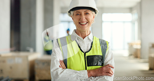Image of Senior woman, architect and smile with arms crossed in success for industrial architecture or construction site. Portrait of confident elderly female engineer or building contractor smiling at work