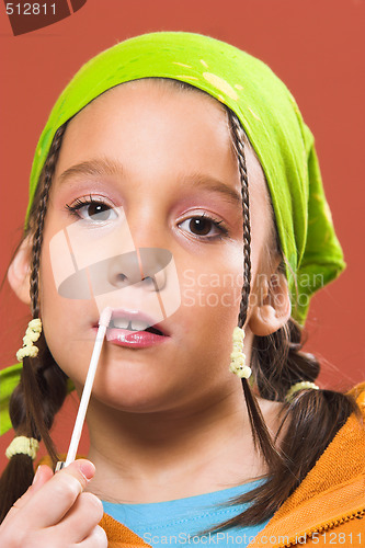 Image of child applying make-up