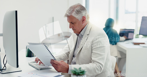 Image of Business man, computer and documents while working in a office for data analysis while typing online doing research. Senior entrepreneur at his desk with a file for information on a finance report