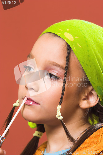 Image of child applying make-up