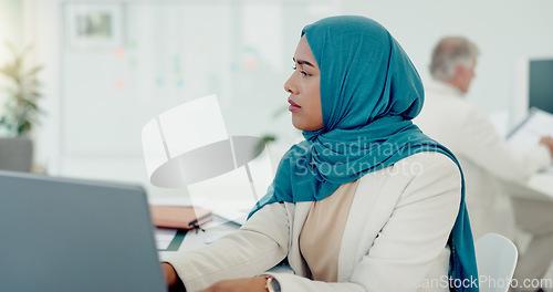 Image of Muslim, business woman and typing on computer in office, startup company and digital management, internet planning and strategy review. Employee with islamic hijab working online for seo website tech