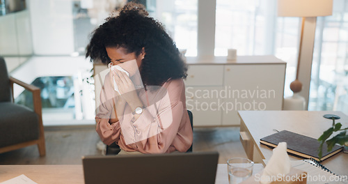 Image of Black woman, covid and sinus in office with sneeze, tissue and runny nose while working on laptop. Business woman, allergies and unwell corporate employee sneezing and suffering flu, cold and allergy