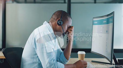 Image of Call center, black man and headache on computer from stress, burnout and desktop glitch, pain and crisis. Frustrated telemarketing consultant tired of pc web problem, poor sales service and challenge