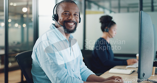 Image of Call center, customer support and face of black man at desk working on computer, online and telemarketing. Crm, contact us and portrait of consultant for friendly service, help and customer service