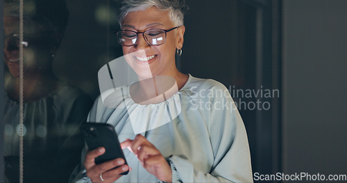 Image of Smartphone, night and senior business woman on mobile app for global networking, funny meme or social media. Happy corporate worker using phone or cellphone in dark office for digital communication