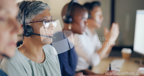Image of Senior agent face, call center and woman on phone call with customer, contact us and CRM with communication. Customer service, telemarketing and tech support with headset and work in coworking space