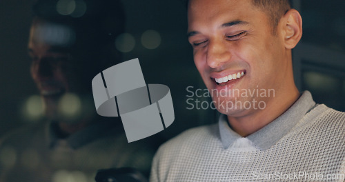 Image of Face, phone and dark with a business man laughing in an office, working late at night on a deadline. Mockup, contact and good news with a male employee typing a text message at work during overtime