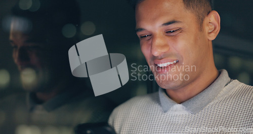 Image of Face, phone and dark with a business man laughing in an office, working late at night on a deadline. Mockup, contact and good news with a male employee typing a text message at work during overtime