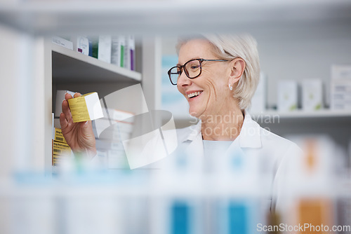 Image of Pharmacy, pharmacist and senior woman with medicine, pills or box in drugstore. Healthcare, wellness or happy medical doctor laughing and reading label on medication or drugs, vitamins or supplements