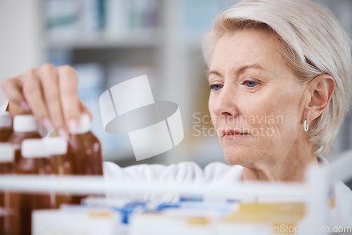 Image of Senior woman, pharmacist and medical stock check in a pharmacy for drug information. Healthcare, wellness and working elderly person with pharmaceutical drugs reading bottle product ingredients