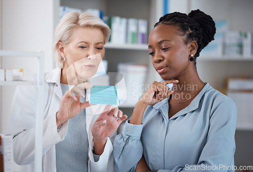 Image of Healthcare, help and black woman with medicine from a pharmacist, dosage information and recommendation. Medical, sick and doctor reading label on a box of pills with an African patient for medicare