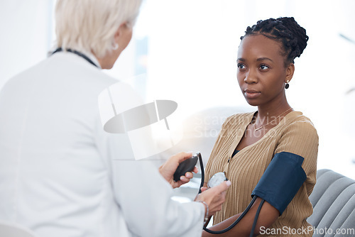 Image of Healthcare, checkup and black woman with a doctor for blood pressure, hypertension and cardiology. Medical, service and African patient with a gp for a routine consultation to monitor the heart