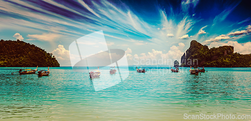 Image of Long tail boat at beach on sunset