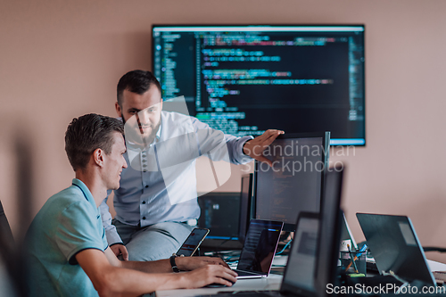 Image of Programmers engrossed in deep collaboration, diligently working together to solve complex problems and develop innovative mobile applications with seamless functionality.