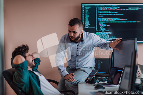 Image of Programmers engrossed in deep collaboration, diligently working together to solve complex problems and develop innovative mobile applications with seamless functionality.