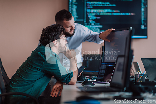 Image of Programmers engrossed in deep collaboration, diligently working together to solve complex problems and develop innovative mobile applications with seamless functionality.