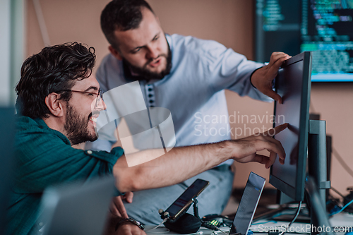 Image of Programmers engrossed in deep collaboration, diligently working together to solve complex problems and develop innovative mobile applications with seamless functionality.