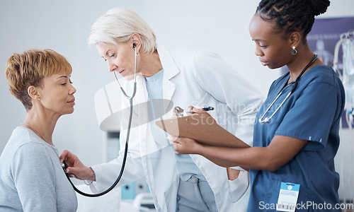 Image of Checkup, routine and woman with doctors for healthcare, consulting and check on health. Medical, cardiology and mature patient with a gp and nurse for an appointment, examination or vitality tests