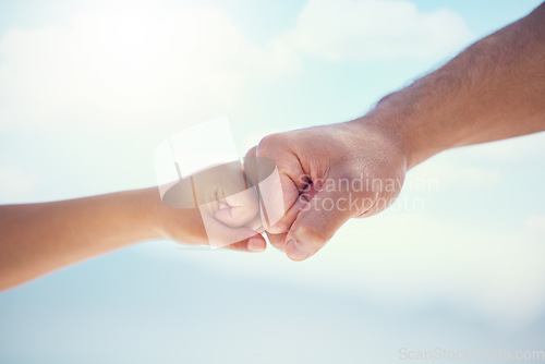 Image of Hands, fist bump and growth in unity, partnership or trust for childhood development on mockup. Small and big hand bumping fists in support, collaboration or teamwork for community or friendship