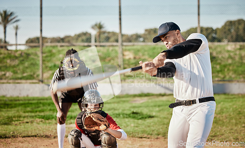 Image of Baseball, bat and swinging with a sports man outdoor, playing a competitive game during summer. Fitness, health and exercise with a male athlete or player training on a field for sport or recreation
