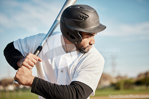 Image of Baseball, bat and serious with a sports man outdoor, playing a competitive game during summer. Fitness, health and exercise with a male athlete or player training on a field for sport or recreation