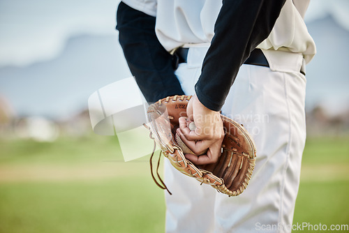 Image of Hands, back view or baseball player training for a game or match on outdoor field or sports stadium. Fitness, softball or focused man pitching or holding a ball with glove in workout or exercise