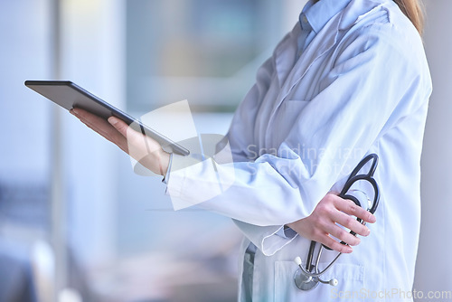 Image of Digital tablet, healthcare and doctor in the hospital analyzing test results or doing research. Technology, stethoscope and professional female medical worker reading information on a mobile device.