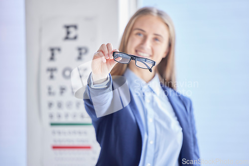 Image of Optometry, vision and portrait of a woman with glasses with prescription lens after a eye test. Healthcare, eyewear and female patient or customer holding spectacles frame for sight in optical store.