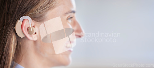 Image of Mockup, deaf and woman with ear piece, disability and health against a grey studio background. Female, lady and hearing aid for help, success with tech and happiness with listening device and medical