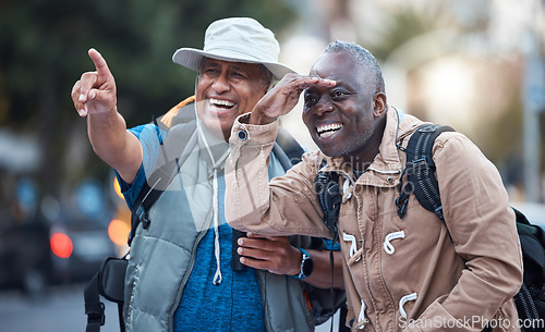 Image of Travel, city tourism and men pointing on walk, explore vacation or tourist adventure in retirement. Happy friends, sightseeing search and smile on outdoor journey, direction or fun holiday experience