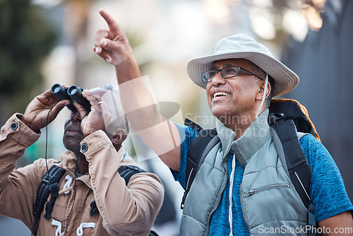 Image of Binoculars, city and men pointing outdoor for travel, explore vacation or tourist adventure walk. Happy friends, tourism and sightseeing search in sky, lens or journey direction of holiday experience