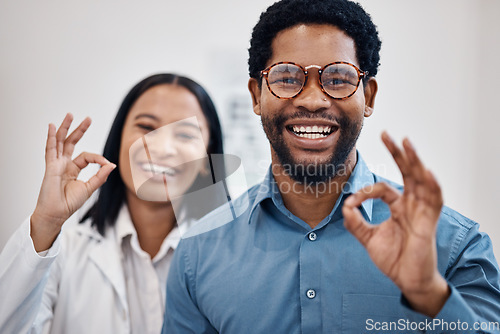 Image of Perfect, optometry and portrait of a black man and optician with glasses, eyecare and choice of eyewear. Okay, happy and patient with a decision on eyeglasses with an optometrist and hand gesture