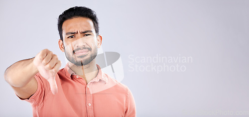 Image of Fail, thumbs down and portrait of Asian man in studio isolated on a gray background mockup. Dislike hand gesture, emoji and face of sad male model with sign for disagreement, rejection or bad review.